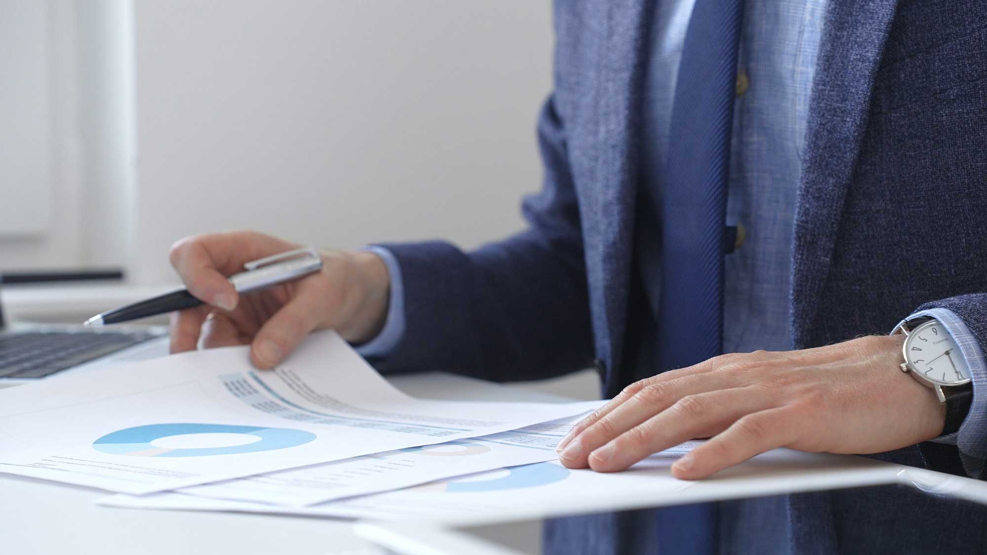 close up of professionals writing on a notebook