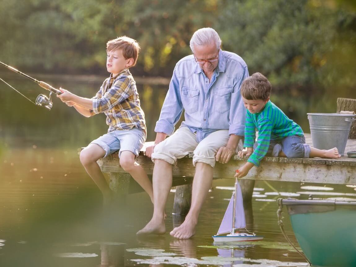 Grandparent with grandchildren fishing 